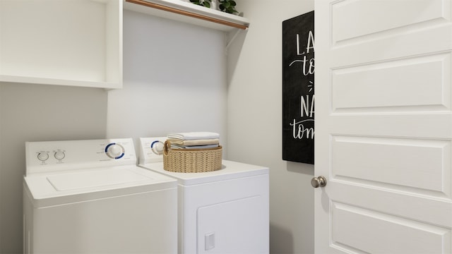 clothes washing area with washing machine and clothes dryer