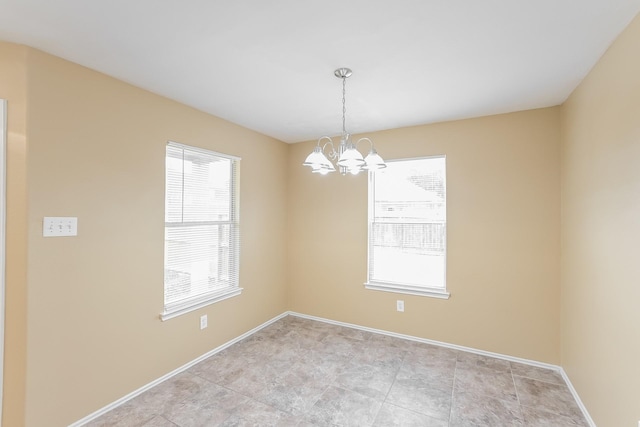 empty room featuring a chandelier