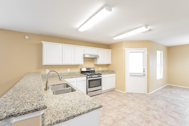 kitchen with white cabinetry, stainless steel gas range, sink, and kitchen peninsula