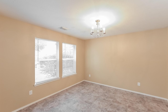 spare room with a chandelier