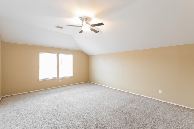 additional living space with light carpet, vaulted ceiling, and ceiling fan