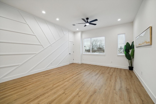 empty room with light wood-type flooring, baseboards, a ceiling fan, and recessed lighting