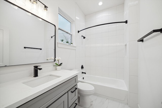 bathroom with toilet, marble finish floor, washtub / shower combination, and vanity