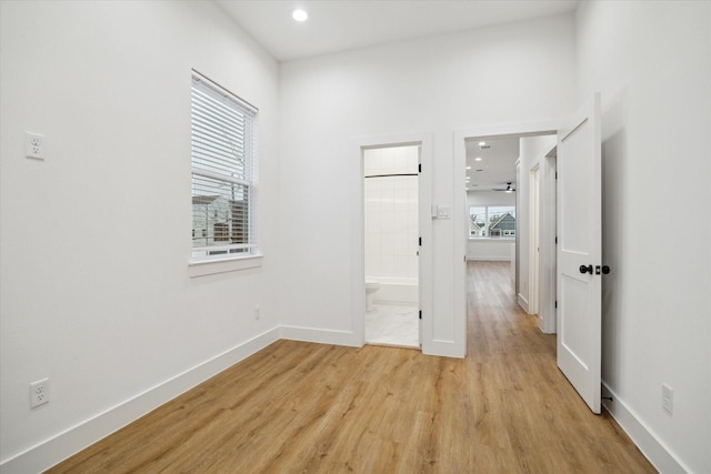 empty room featuring light wood-style flooring, baseboards, and recessed lighting