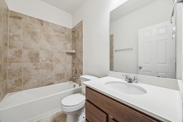 full bathroom featuring vanity, tile patterned flooring, toilet, and tiled shower / bath