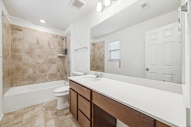 full bathroom with vanity, tile patterned floors, toilet, and tiled shower / bath