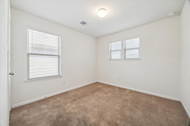 unfurnished room with carpet floors