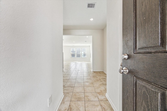 hallway featuring light tile patterned floors