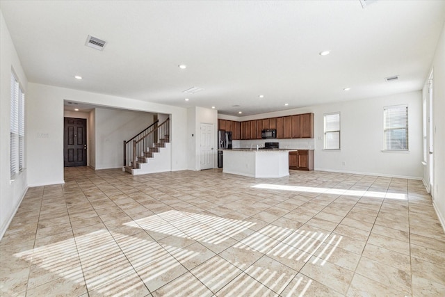 unfurnished living room featuring light tile patterned floors