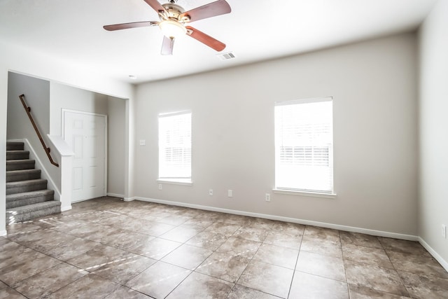 spare room featuring tile patterned floors and ceiling fan