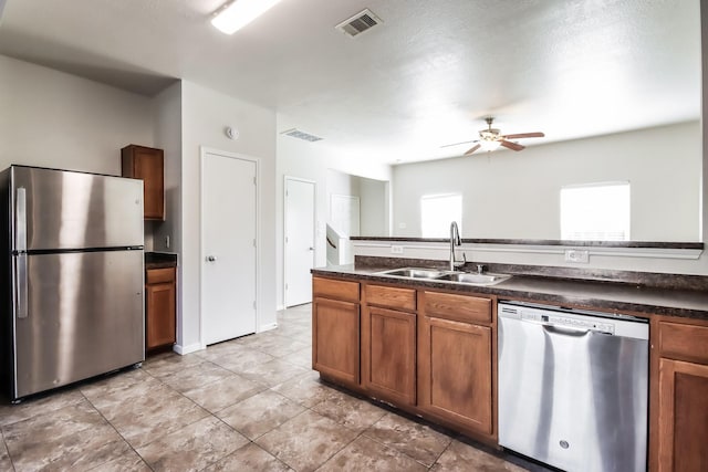 kitchen featuring sink, stainless steel appliances, ceiling fan, and light tile patterned flooring