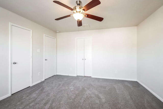 unfurnished bedroom featuring ceiling fan and dark colored carpet