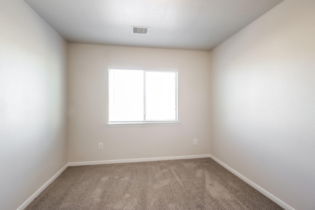 empty room featuring light carpet