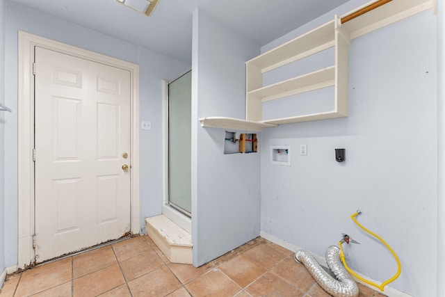 washroom with washer hookup, laundry area, hookup for an electric dryer, and light tile patterned flooring