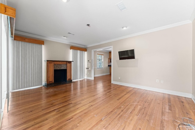 unfurnished living room with ornamental molding, wood finished floors, and a high end fireplace