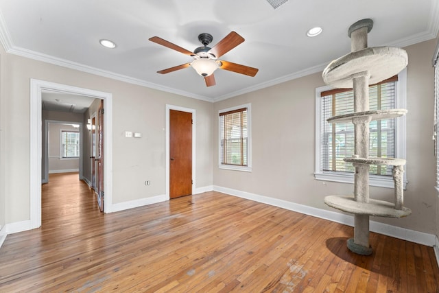 unfurnished room with ceiling fan, crown molding, baseboards, and wood finished floors