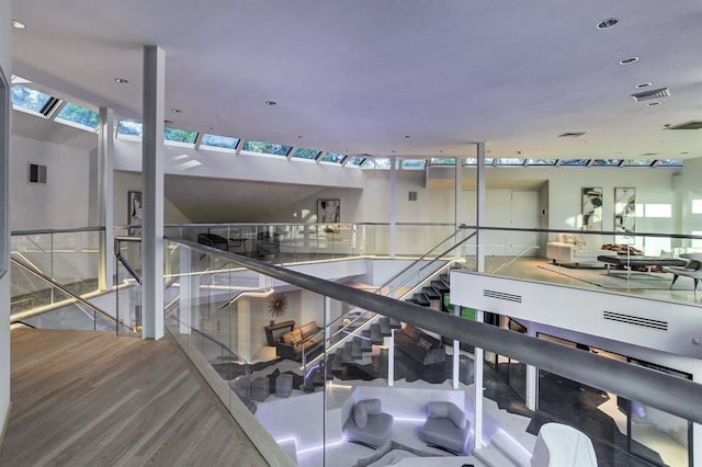 stairs with hardwood / wood-style floors and a wealth of natural light