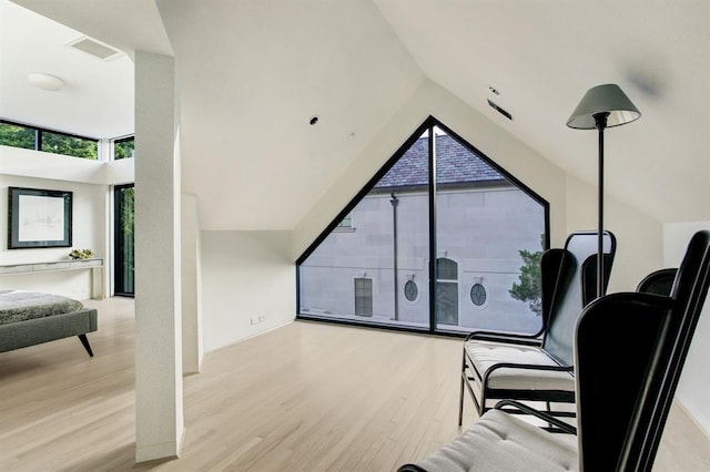 living area with light hardwood / wood-style floors and lofted ceiling