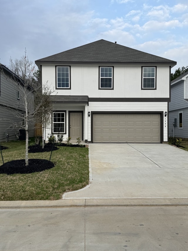 view of property featuring a garage and a front yard