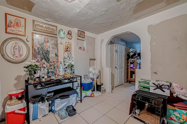 miscellaneous room featuring a textured ceiling and light tile patterned floors