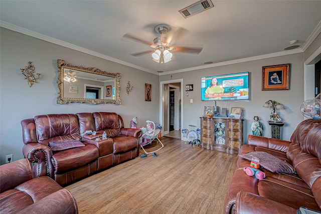 living room with crown molding, ceiling fan, and light hardwood / wood-style floors