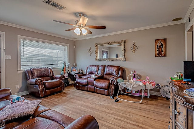 living room featuring ornamental molding, ceiling fan, and light wood-type flooring