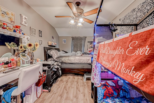 bedroom featuring ceiling fan, lofted ceiling, and light wood-type flooring