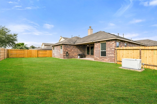 rear view of property with a lawn