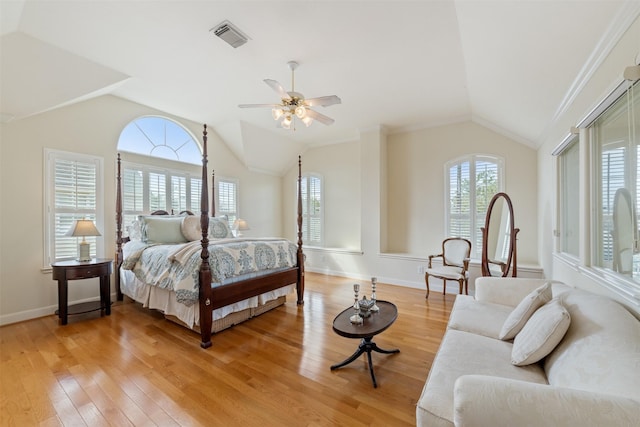 bedroom featuring multiple windows, hardwood / wood-style flooring, vaulted ceiling, and ceiling fan