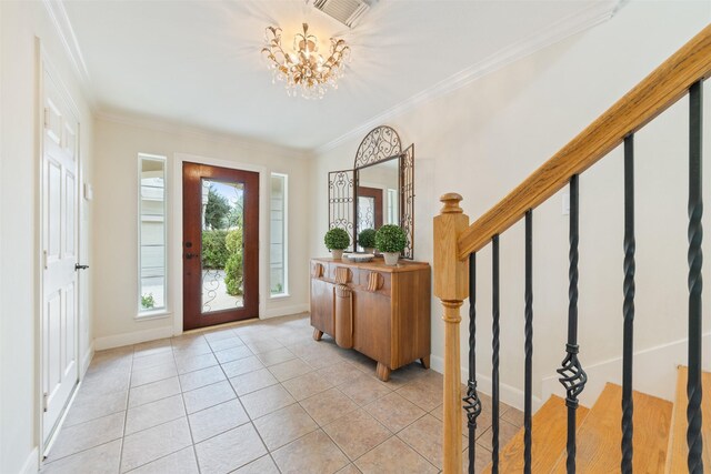 foyer featuring light tile patterned floors, crown molding, and a chandelier