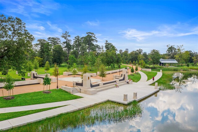 view of community with a water view and a yard