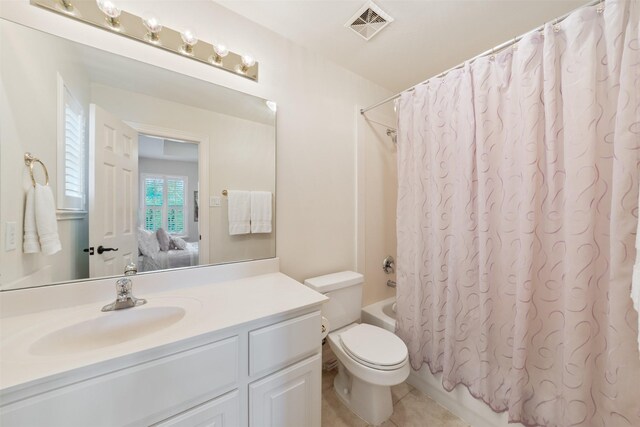 full bathroom featuring toilet, tile patterned floors, shower / bathtub combination with curtain, and vanity