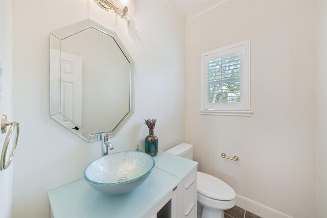 bathroom featuring ornamental molding, vanity, and toilet