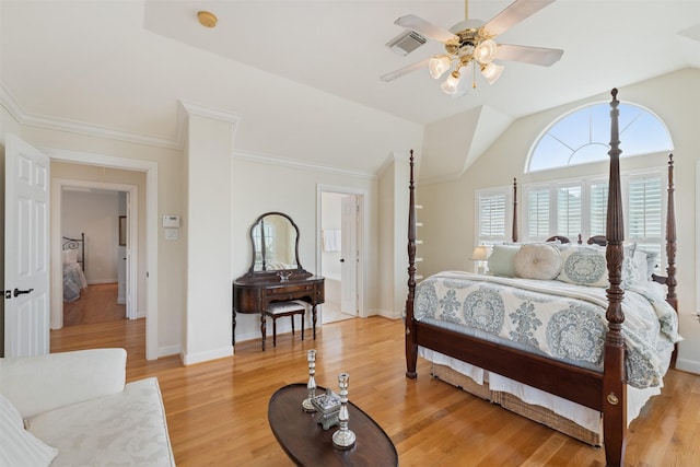 bedroom featuring crown molding, lofted ceiling, ceiling fan, and light wood-type flooring