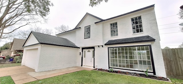 view of front facade featuring a garage and a front lawn