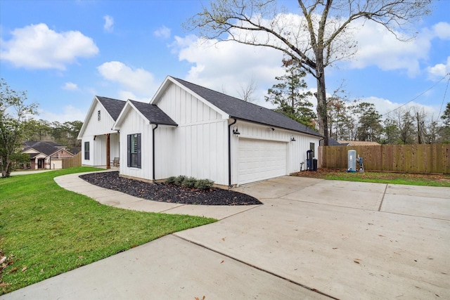 view of side of home with a yard and a garage