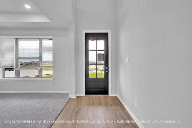 carpeted foyer entrance with baseboards