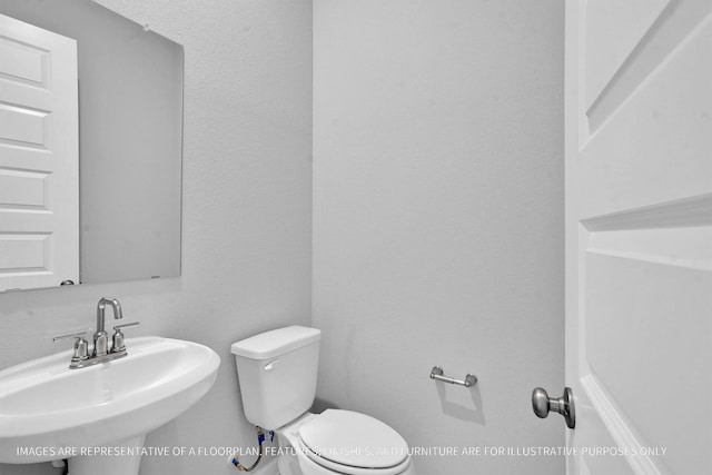 bathroom featuring toilet and a sink