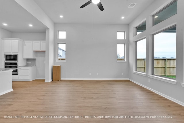 unfurnished living room featuring visible vents, recessed lighting, light wood finished floors, baseboards, and ceiling fan