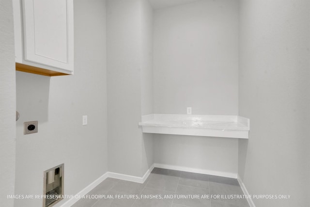 laundry area with baseboards, cabinet space, hookup for an electric dryer, and tile patterned flooring