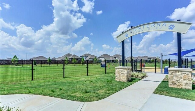 view of property's community with a yard and fence