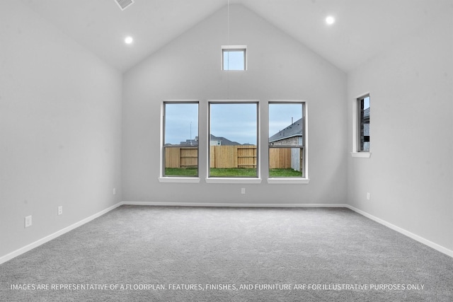 empty room featuring recessed lighting, carpet, baseboards, and high vaulted ceiling