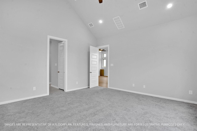 unfurnished bedroom with baseboards, visible vents, carpet floors, and high vaulted ceiling