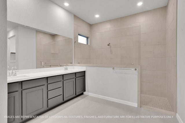 bathroom with double vanity, recessed lighting, walk in shower, and a sink