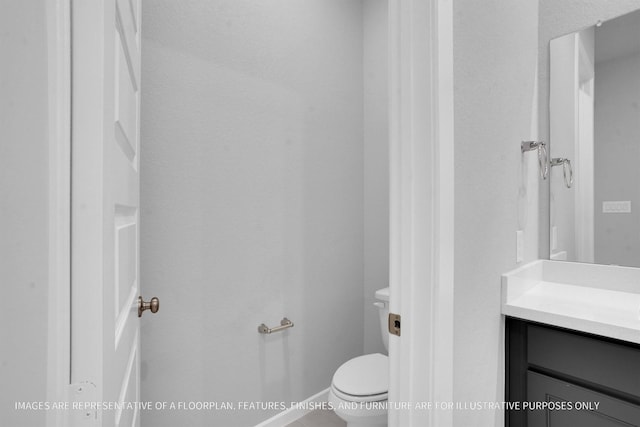 bathroom featuring toilet and vanity