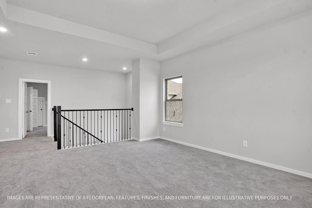 empty room featuring carpet flooring, recessed lighting, and baseboards