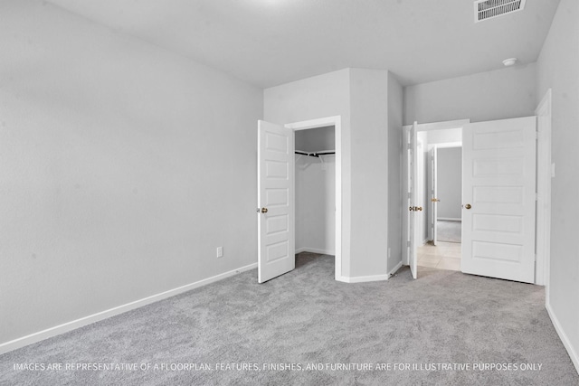 unfurnished bedroom with a closet, visible vents, carpet flooring, and baseboards