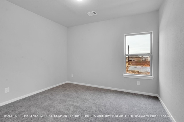 carpeted empty room with visible vents and baseboards