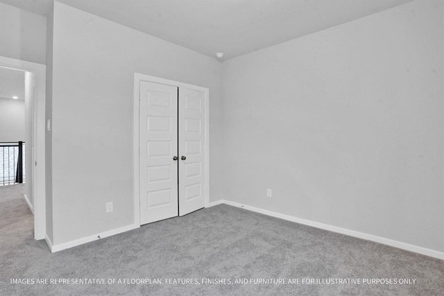 unfurnished bedroom featuring a closet, baseboards, and carpet floors