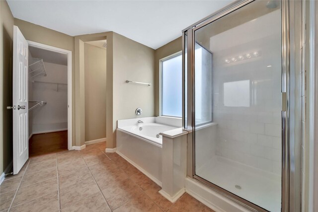 bathroom with tile patterned flooring and separate shower and tub